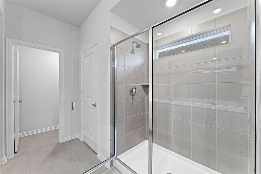 Bathroom with a stall shower, recessed lighting, and tile patterned flooring Bathroom with a stall shower, recessed lighting, and tile patterned flooring