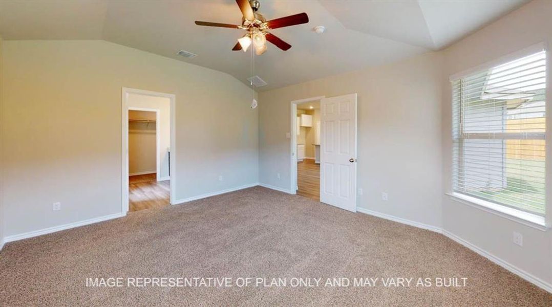 Unfurnished bedroom featuring vaulted ceiling, a spacious closet, light colored carpet, and ceiling fan Unfurnished bedroom featuring vaulted ceiling, a spacious closet, light colored carpet, and ceiling fan