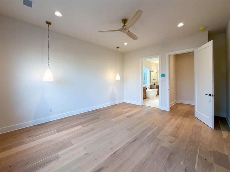 Light wood-finish flooring complements the neutral wall tones