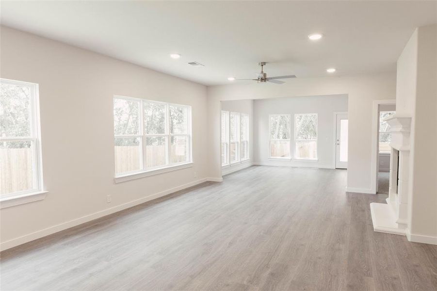 Unfurnished living room with light hardwood / wood-style flooring and ceiling fan