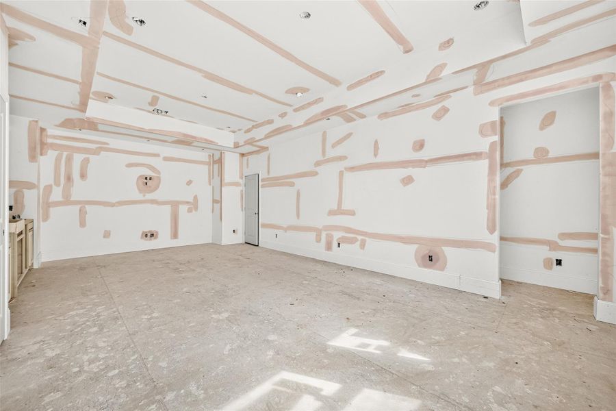 View of game room with access to the 5th bedroom on the right and attic access across from the wet bar