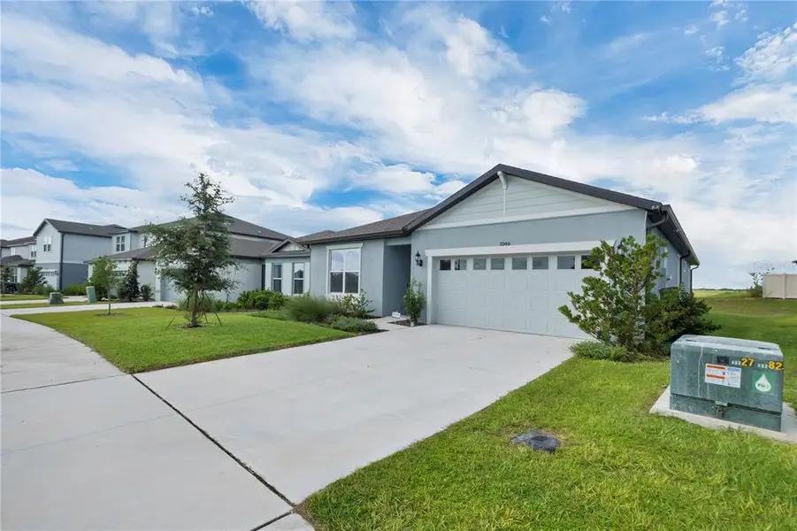 Front exterior of a new home in , Lake Alfred, FL, highlighting curb appeal (Image 2). Front exterior of a new home in , Lake Alfred, FL, highlighting curb appeal (Image 2).