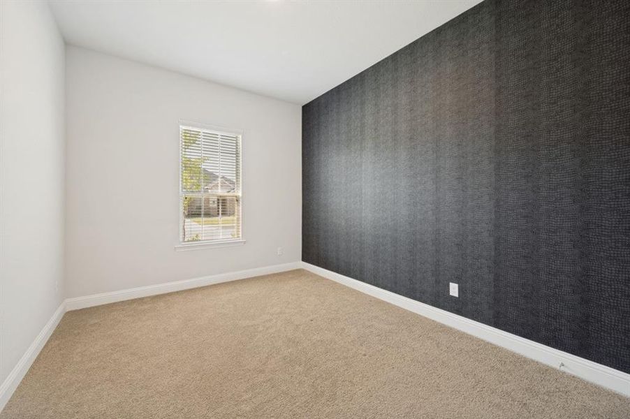 Neutral-toned carpeting paired with white baseboards