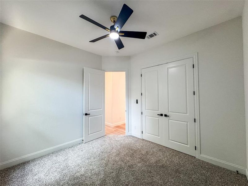 Unfurnished bedroom with carpet floors, baseboards, a closet, and ceiling fan Unfurnished bedroom with carpet floors, baseboards, a closet, and ceiling fan