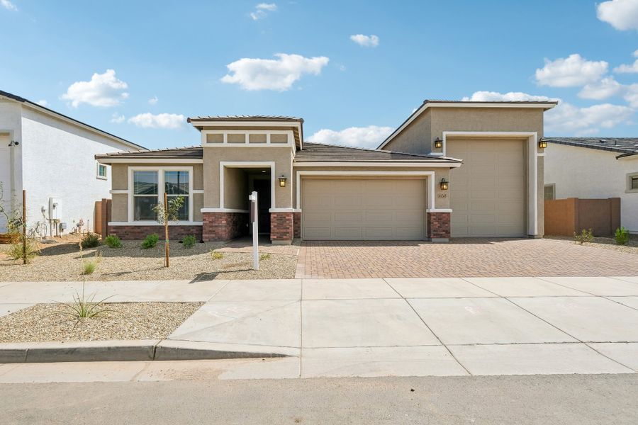 Front exterior of a new home in Artisan at Asante, Surprise, AZ, highlighting curb appeal (Image 1). Front exterior of a new home in Artisan at Asante, Surprise, AZ, highlighting curb appeal (Image 1).