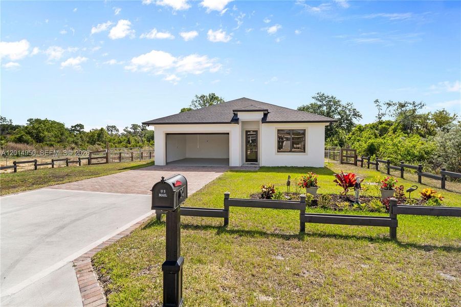 Front exterior and fenced entry view