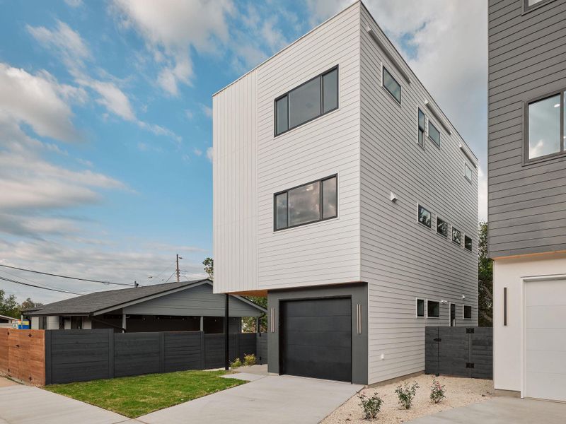 Modern home featuring concrete driveway and an attached garage