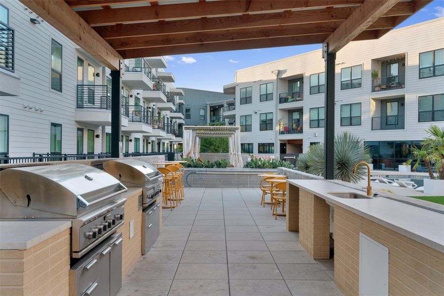 View of patio / terrace featuring an outdoor kitchen and a sink