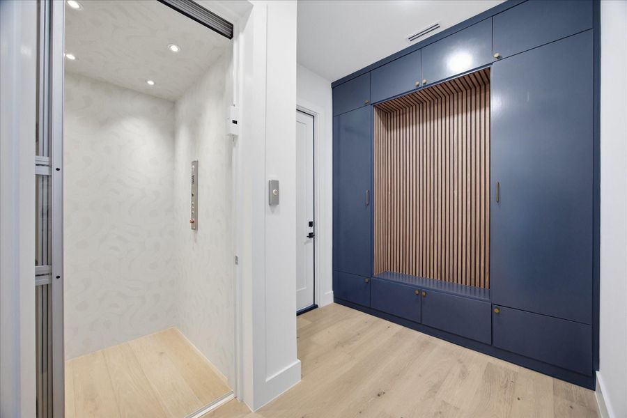 Function meets sophistication—featuring a custom mudroom alongside a private elevator for effortless, multi-level living.