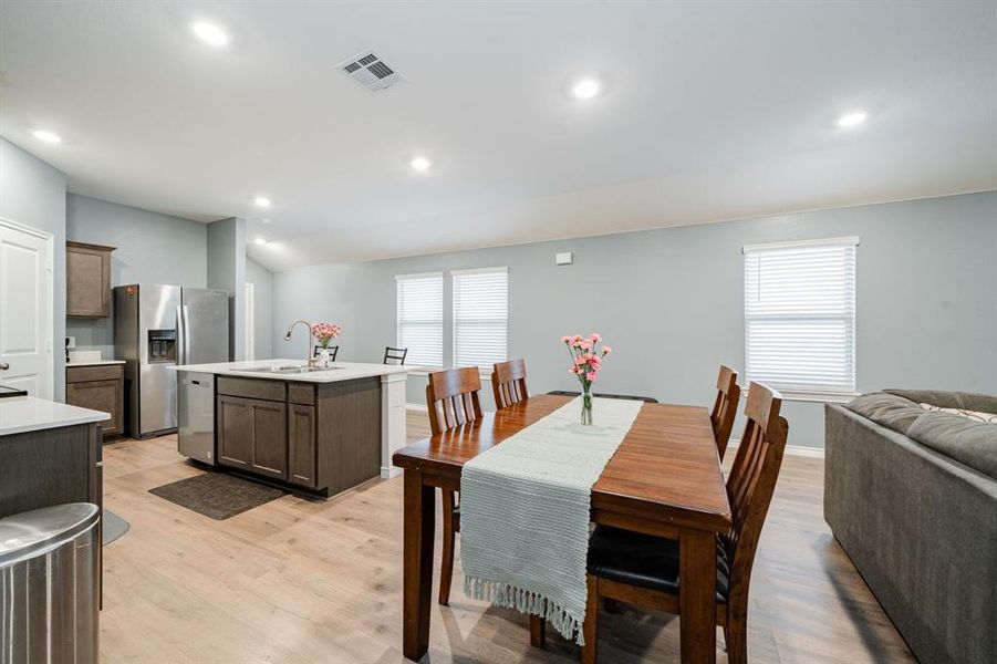 Dining room featuring light wood-type flooring, recessed lighting, plenty of natural light, and lofted ceiling Dining room featuring light wood-type flooring, recessed lighting, plenty of natural light, and lofted ceiling
