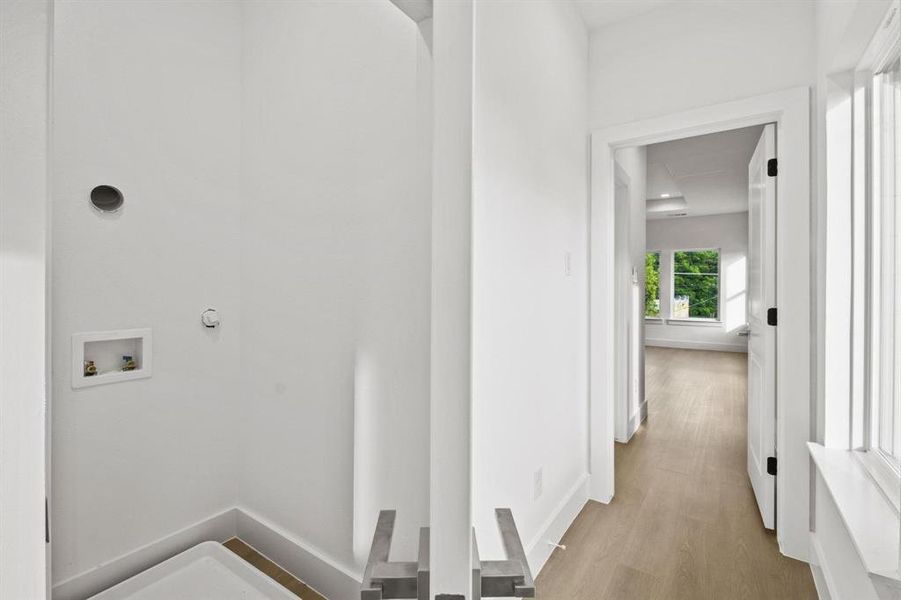 Washroom featuring light wood-type flooring and hookup for a washing machine