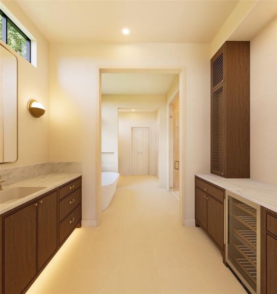 A private retreat designed with quiet intention, this bath unfolds in layers—dual vanities, integrated storage, and a dedicated beverage station leading to a serene soaking space beyond. Every detail is curated to elevate daily rituals.