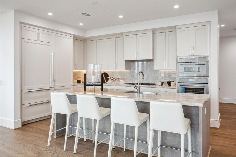 Stunning chef’s kitchen boasts sleek, modern design paired with top-of-the-line functionality.