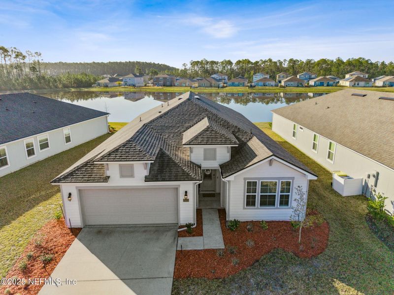 Front exterior of a new home in River Glen, Yulee, FL, highlighting curb appeal (Image 21). Front exterior of a new home in River Glen, Yulee, FL, highlighting curb appeal (Image 21).