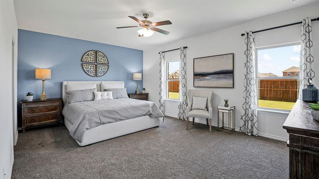 Bedroom featuring a ceiling fan and dark carpet