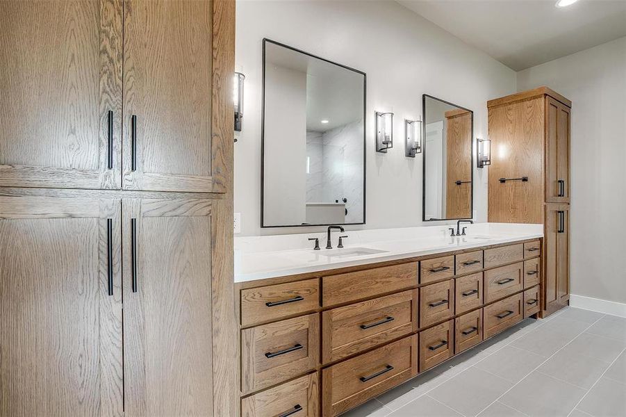 Bathroom featuring double vanity and tile patterned floors Bathroom featuring double vanity and tile patterned floors