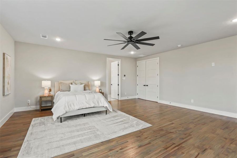 Bedroom featuring a ceiling fan, recessed lighting, and dark wood-type flooring Bedroom featuring a ceiling fan, recessed lighting, and dark wood-type flooring
