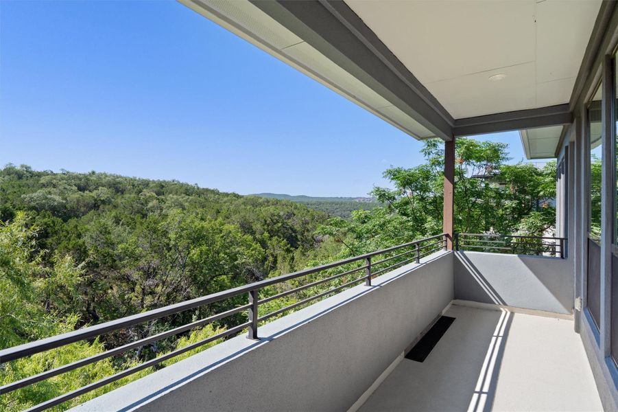 An inviting balcony offers serene forest and distant hill views, perfect for peaceful mornings. An inviting balcony offers serene forest and distant hill views, perfect for peaceful mornings.