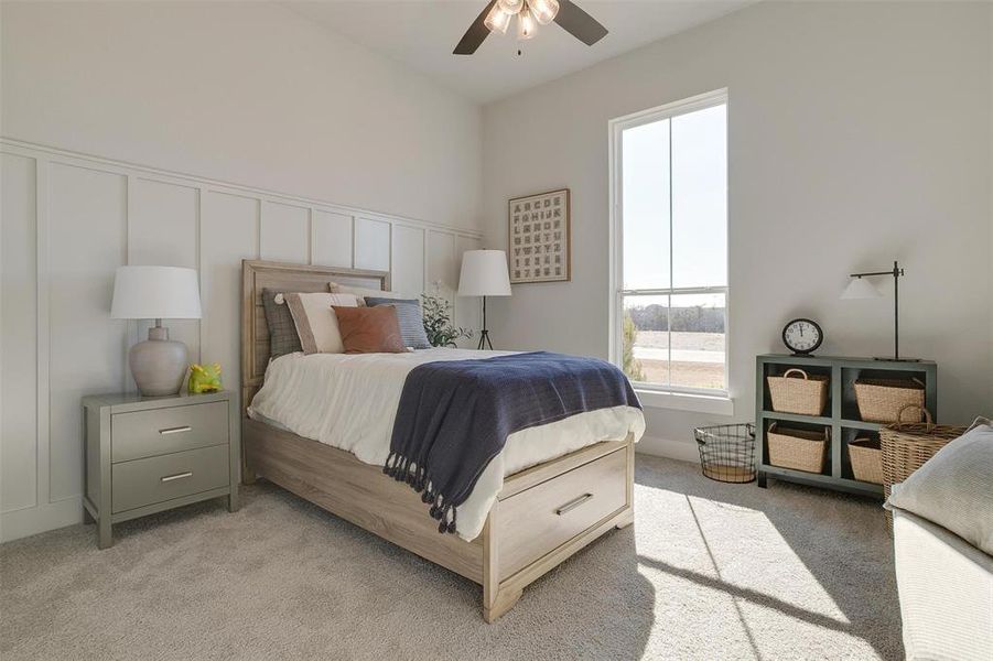 Bedroom with ceiling fan and light colored carpet