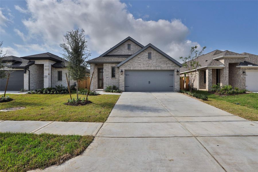 Front exterior of a new home in The Grand Prairie, Hockley, TX, highlighting curb appeal (Image 2). Front exterior of a new home in The Grand Prairie, Hockley, TX, highlighting curb appeal (Image 2).
