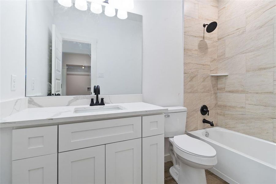 Second full bathroom with tiled shower/tub combo