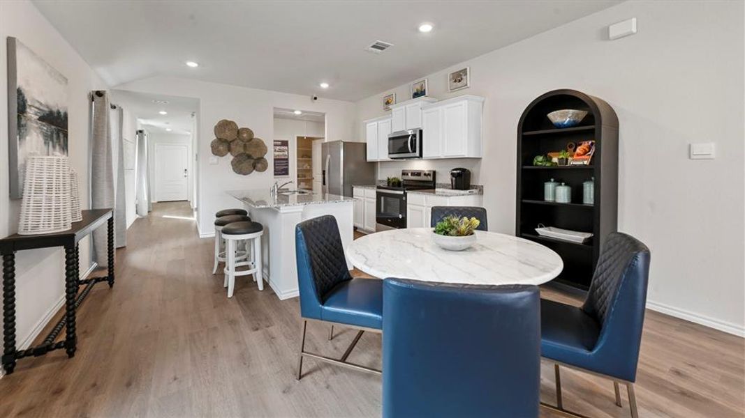 Dining space featuring recessed lighting and light wood-style floors Dining space featuring recessed lighting and light wood-style floors