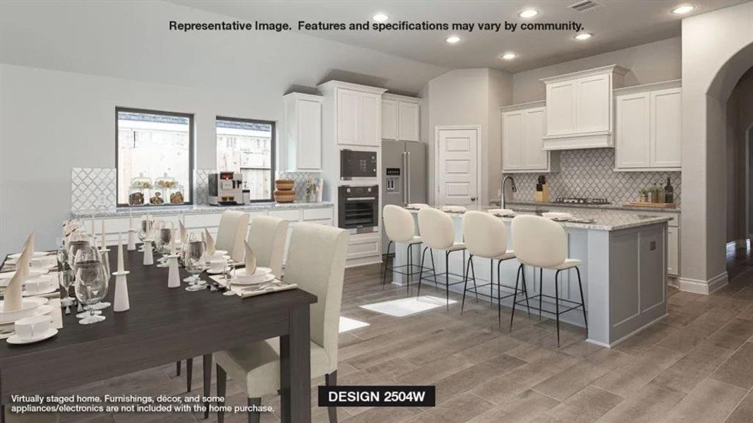 Kitchen with hardwood / wood-style floors, a breakfast bar area, appliances with stainless steel finishes, white cabinetry, and a kitchen island with sink