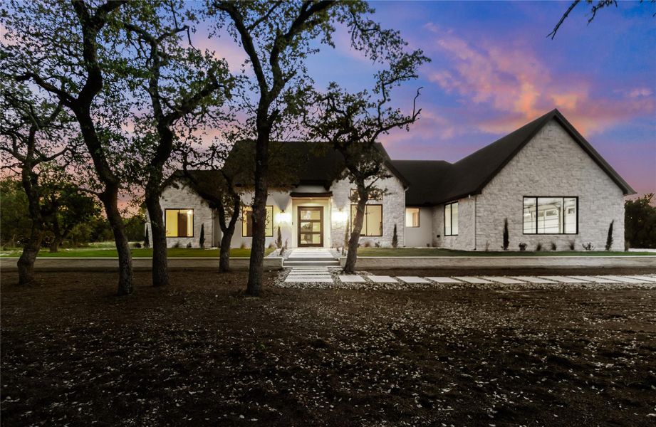 Front exterior of a new home in , Dripping Springs, TX, highlighting curb appeal (Image 2). Front exterior of a new home in , Dripping Springs, TX, highlighting curb appeal (Image 2).