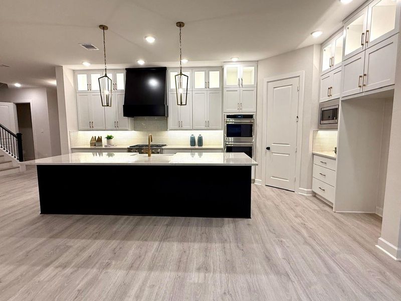 This is a Kitchen that will truly WOW you! You will be captivated with the cabinets to the ceiling with glass doors accented with ribbon lighting! GE Cafe appliances, quartz counters & double oven with 6 burner apron front cooktop! This is a Kitchen that will truly WOW you! You will be captivated with the cabinets to the ceiling with glass doors accented with ribbon lighting! GE Cafe appliances, quartz counters & double oven with 6 burner apron front cooktop!