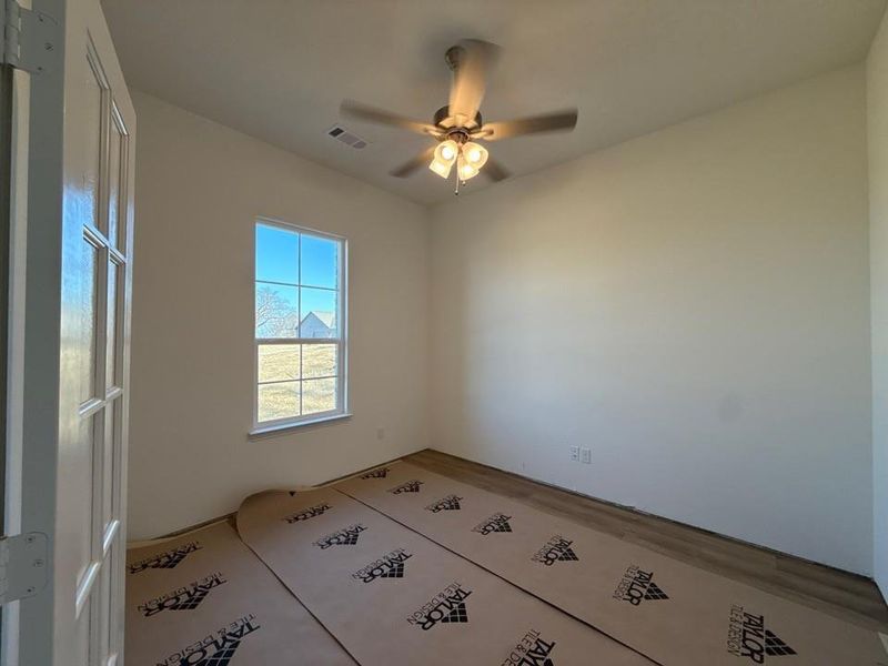 Spare room with ceiling fan