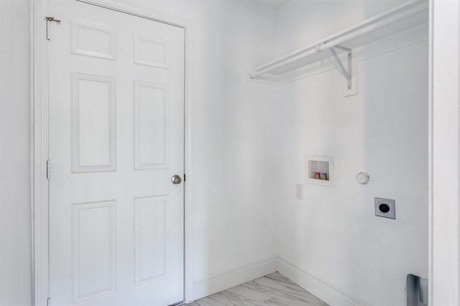 Laundry area featuring washer hookup, light marble finish flooring, gas dryer hookup, and hookup for an electric dryer