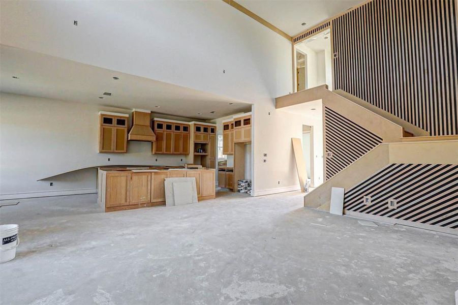 Unfurnished living room with a towering ceiling