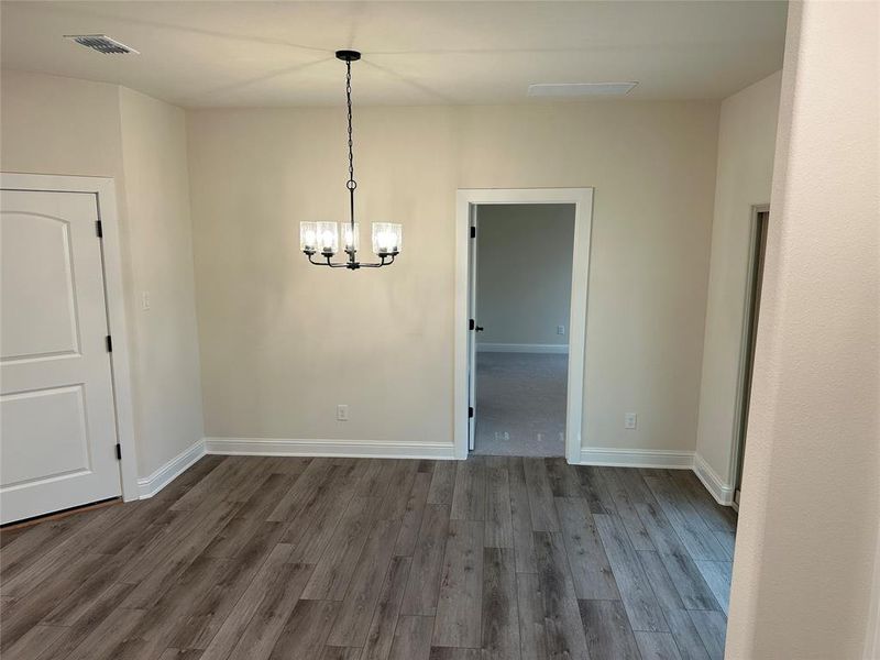 The dining room has a  chandelier and great view to the large backyard.