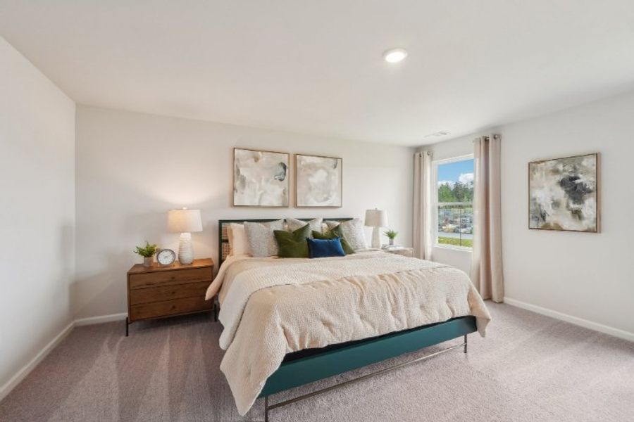 A bedroom with a bed and lamps.