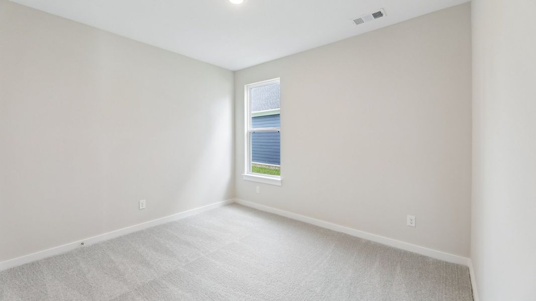 Secondary Bedroom with carpet and window Secondary Bedroom with carpet and window