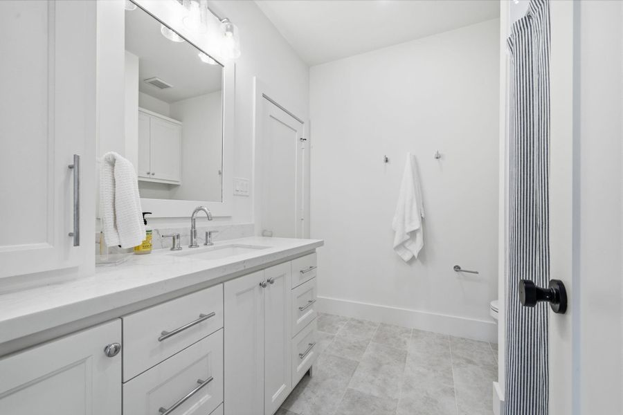 Upstairs bathroom with a door leading to a guest bedroom as well as the hallway next to the game room. Upstairs bathroom with a door leading to a guest bedroom as well as the hallway next to the game room.