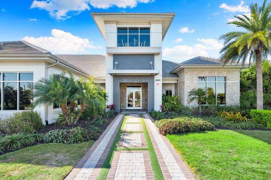 Front exterior of a new home in Esplanade at Azario Lakewood Ranch, Bradenton, FL, highlighting curb appeal (Image 21).