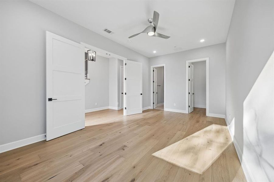 Unfurnished bedroom featuring light wood finished floors, a ceiling fan, and recessed lighting Unfurnished bedroom featuring light wood finished floors, a ceiling fan, and recessed lighting