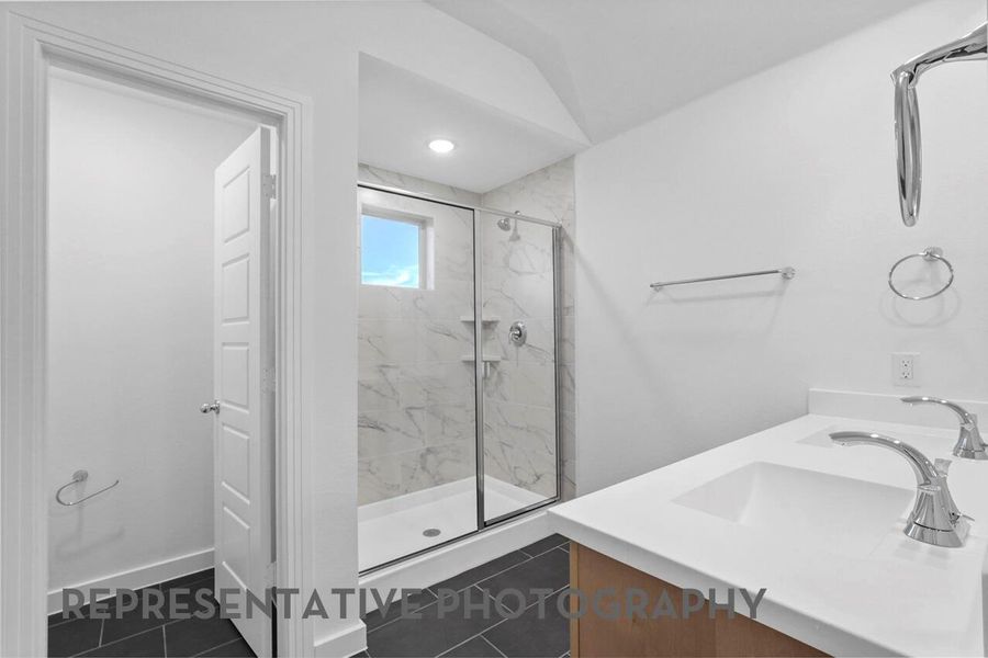 A spacious primary bathroom offers a serene retreat with elegant finishes, ample counter space, and a relaxing atmosphere designed for comfort.