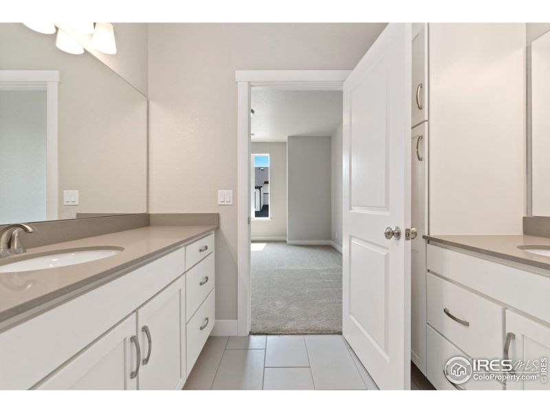 Primary bathroom w/ separate dual vanities