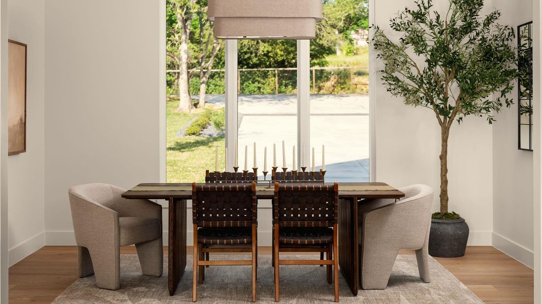 Natural light floods this dining area through large windows, creating an inviting space for gatherings. Natural light floods this dining area through large windows, creating an inviting space for gatherings.