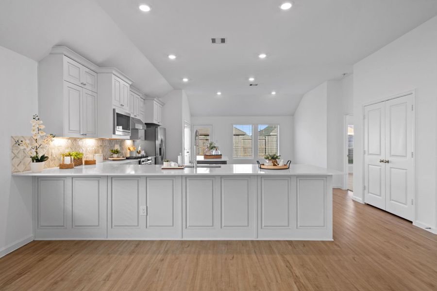 The kitchen sits at the heart of the home, opening directly into the living area so you’re never far from the conversation.