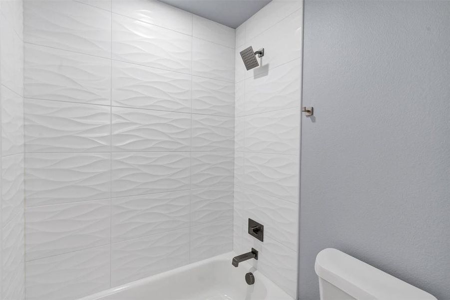 Full bathroom with toilet and shower / bath combination