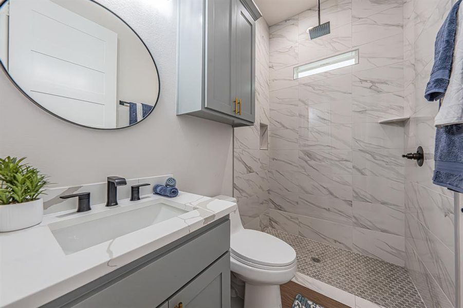 Bathroom featuring a stall shower and vanity Bathroom featuring a stall shower and vanity