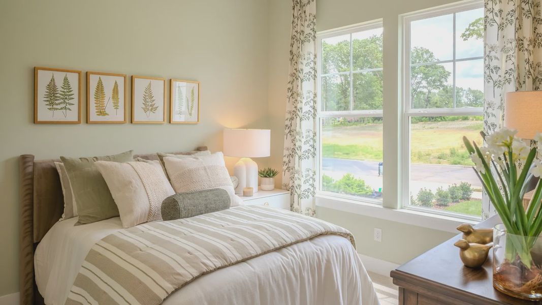 Secondary bedroom with carpet and bright natural light from windows Secondary bedroom with carpet and bright natural light from windows