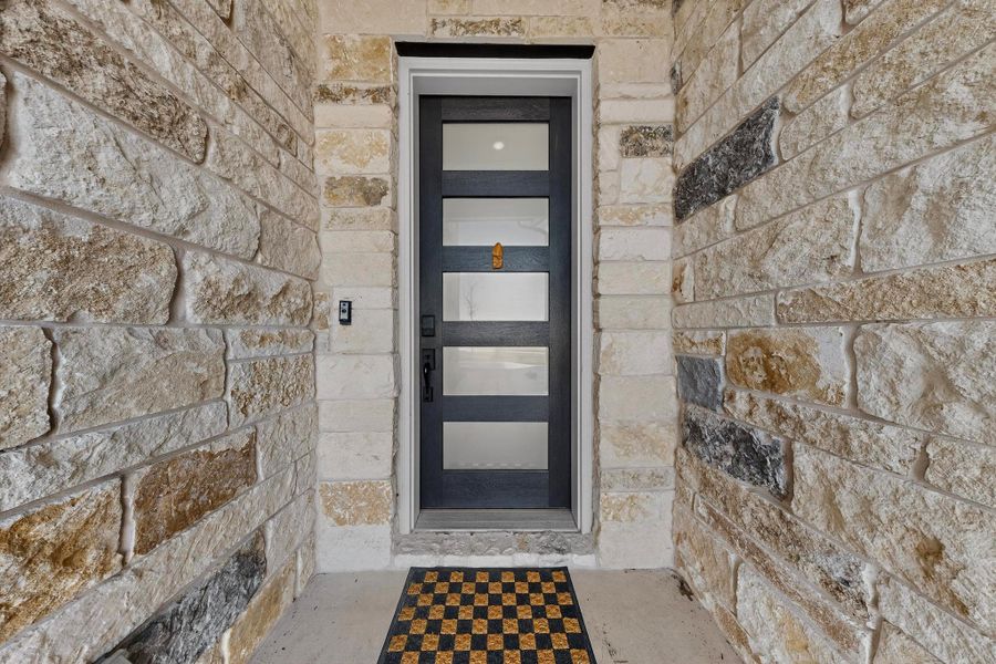 Property entrance featuring stone siding