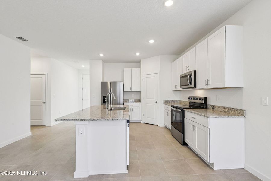Furnished interior view inside a new home in Lakes at Bella Lago - Signature Series, Green Cove Springs (Image 8). Furnished interior view inside a new home in Lakes at Bella Lago - Signature Series, Green Cove Springs (Image 8).