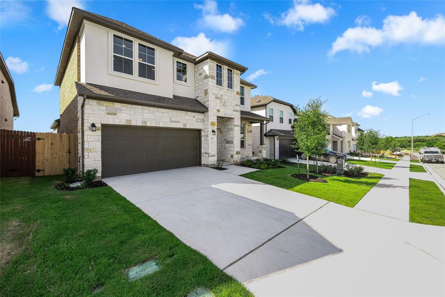 Front exterior of a new home in , Buda, TX, highlighting curb appeal (Image 21).
