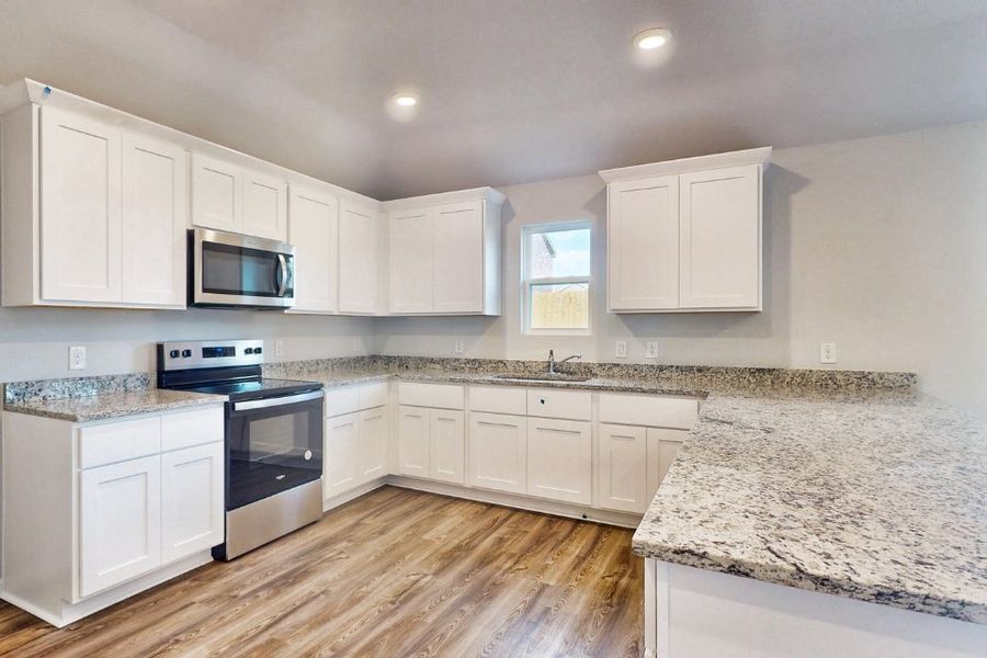 A kitchen with white cabinets. A kitchen with white cabinets.