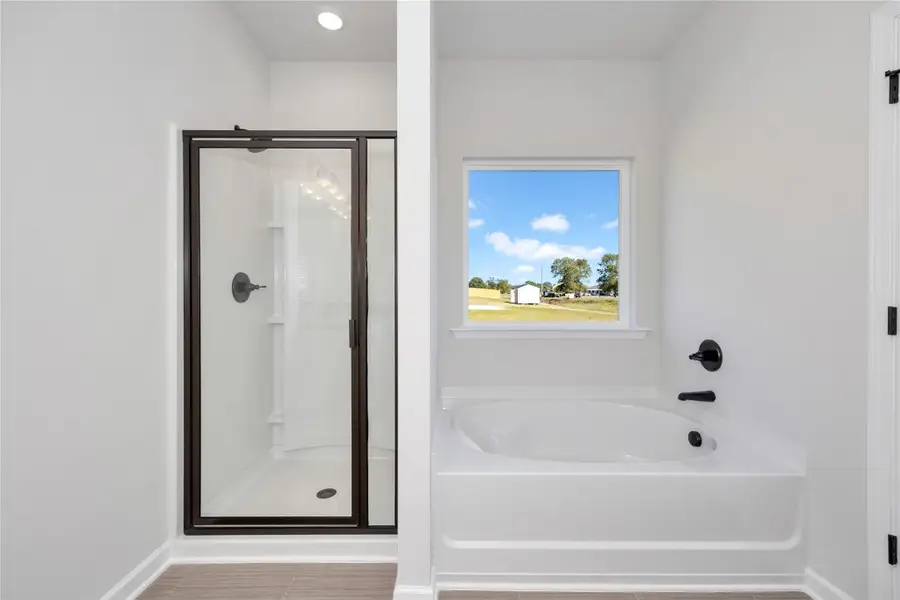 The Pearson- Owner's Bathroom with Garden Tub and Walk-in Shower. Home under construction. Sample floor plan photo used for illustrative purposes only. Upgrades, selections options, and colors will vary.